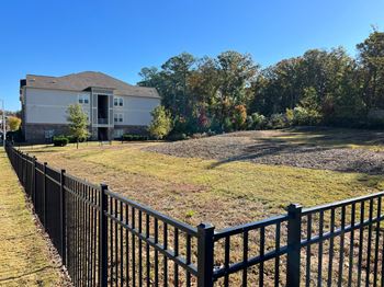 a yard with a fence in front of a house